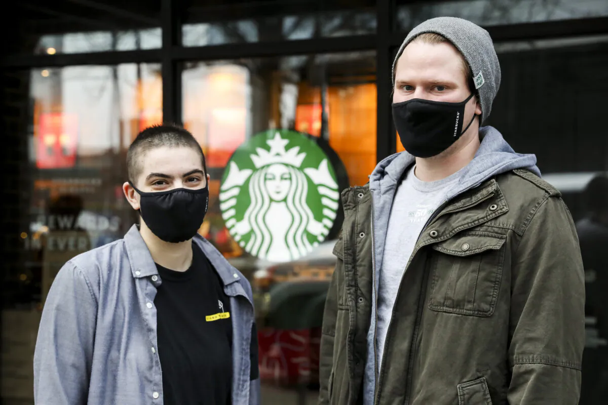 Rachel Ybarra (L) and Justin Ferguson, two members of the union organizing committee, outside their Starbucks in Seattle on Dec. 21, 2021. (Amanda Snyder/Seattle Times/TNS)