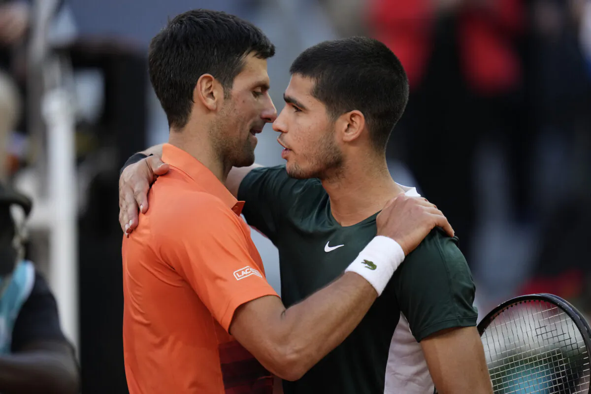 Novak Djokovic (L) with Carlos Alcaraz at the end of a men’s semifinal at the Mutua Madrid Open tennis tournament in Madrid on May 7, 2022. (Manu Fernandez/AP Photo)