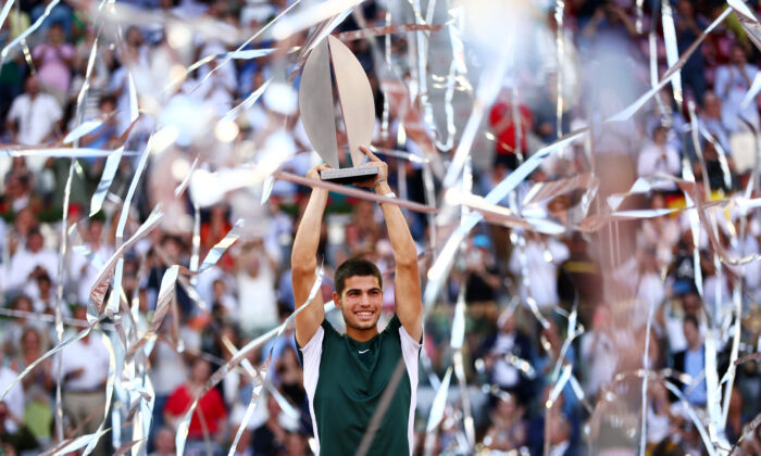 Carlos Alcaraz of Spain lifts the Men's Singles Winner Mutua Madrid Open trophy after his victory in the men's singles final match at La Caja Magica in Madrid, Spain, on May 08, 2022. (Clive Brunskill/Getty Images)