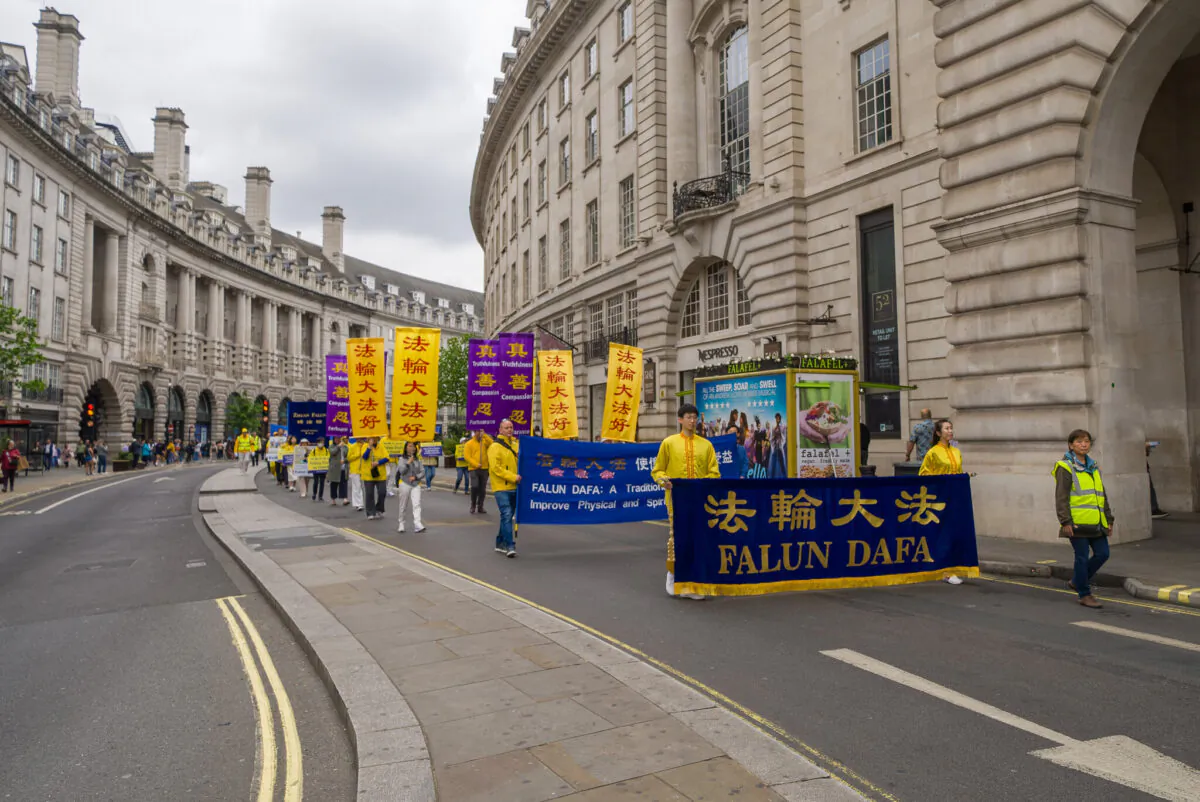 A parade in celebration of World Falun Dafa Day passes through the streets of central London on May 7, 2022. (Yanning Qi/The Epoch Times)