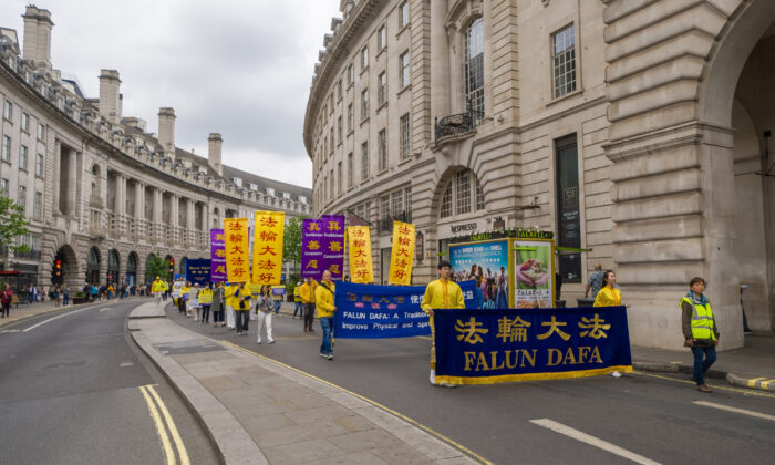 A parade in celebration of World Falun Dafa Day passes through the streets of central London on May 7, 2022. (Yan Ning/Epoch Times) 