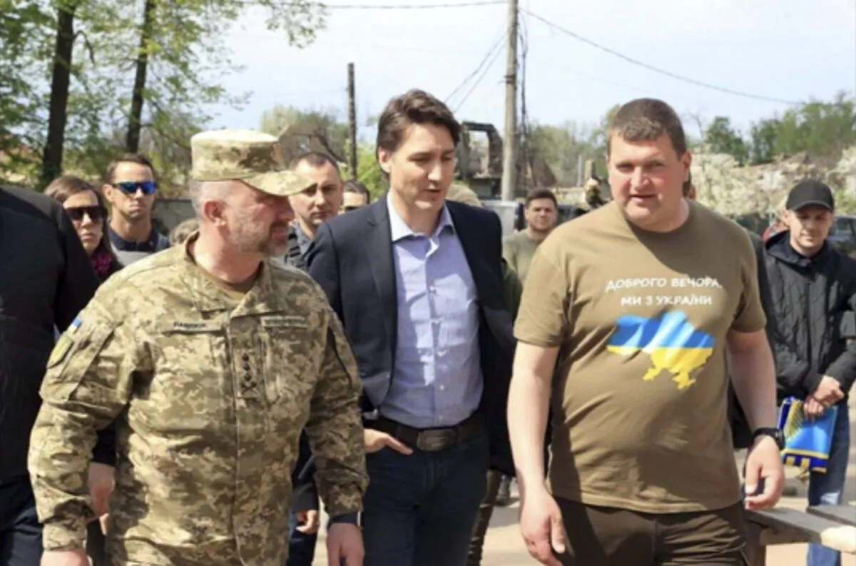 Canadian Prime Minister Justin Trudeau (C) walks with Mayor Oleksandr Markushyn (R) in Irpin, Ukraine, on May 8, 2022. (Irpin Mayor's Office via AP)