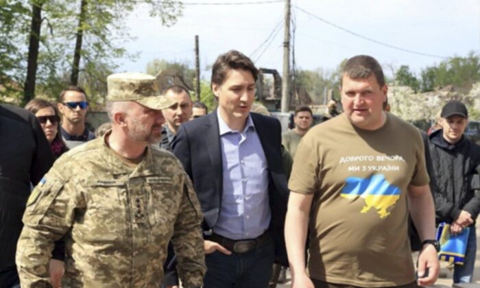 Canadian Prime Minister Justin Trudeau (C) walks with Mayor Oleksandr Markushyn (R) in Irpin, Ukraine, on May 8, 2022. (Irpin Mayor's Office via AP)
