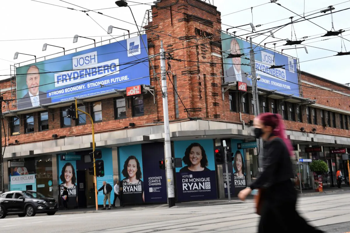 Campaign posters for Climate 200 Independent candidate Monique Ryan and Liberal candidate Federal Treasurer Josh Frydenberg in the seat of Kooyong at Camberwell in Melbourne, Australia, on April 28, 2022. (AAP Image/Joel Carrett)