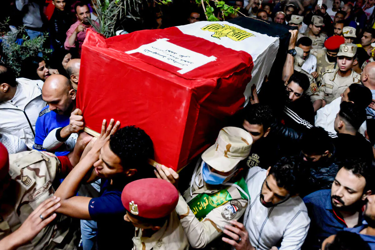 Men carry the coffin of military solider Ahmed Mohamed Ahmed Ali, who was killed in battle, during his funeral service, in Qalyubia province, Egypt, on May 8, 2022. (Sayed Hassan/AP Photo)
