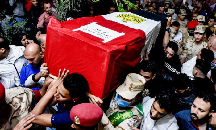Men carry the coffin of military solider Ahmed Mohamed Ahmed Ali, who was killed in battle, during his funeral service, in Qalyubia province, Egypt, on May 8, 2022. (Sayed Hassan/AP Photo)
