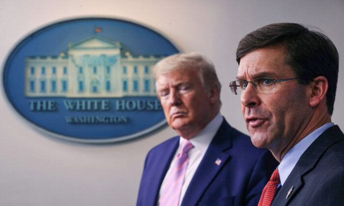 Secretary of Defense Mark Esper speaks as U.S. President Donald Trump listens during the daily White House coronavirus press briefing in Washington on April 1, 2020. (Win McNamee/Getty Images)