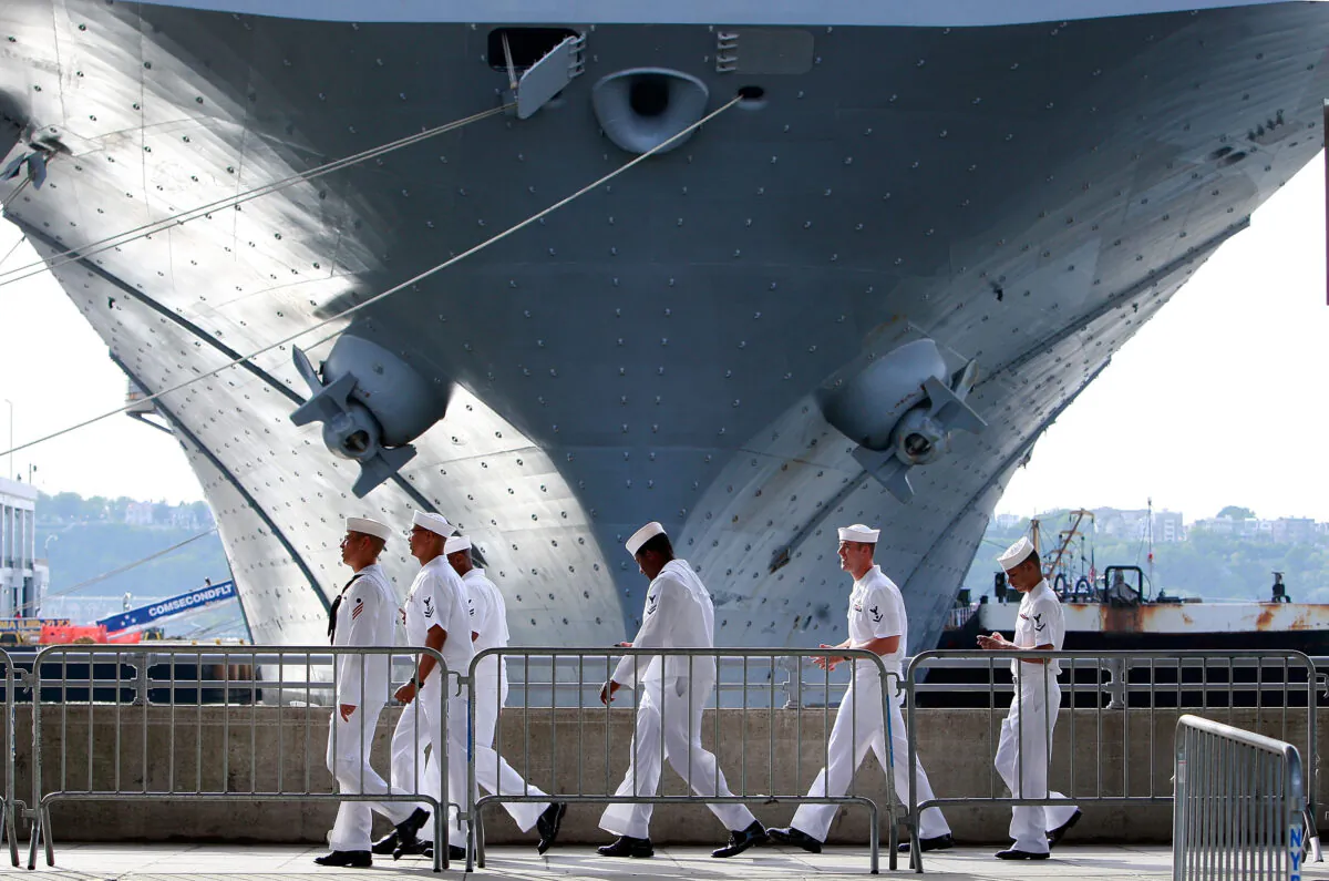 U.S. Navy sailors walk past the USS Iwo Jima docked on the Hudson River during Fleet Week in New York on May 22, 2009. (Mario Tama/Getty Images)