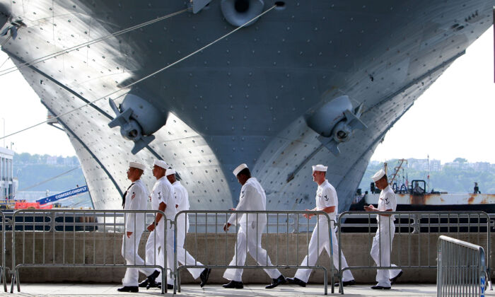 U.S. Navy sailors walk past the USS Iwo Jima docked on the Hudson River during Fleet Week in New York on May 22, 2009. (Mario Tama/Getty Images)