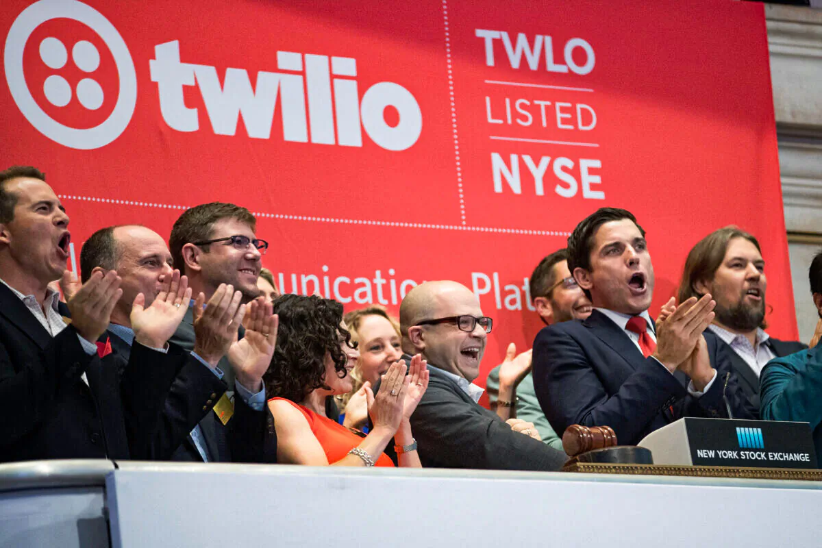 Twilio Inc. founder and CEO Jeff Lawson (C, in glasses) reacts after ringing the opening bell to celebrate Twilio's initial public offering at the New York Stock Exchange on June 23, 2016. (Drew Angerer/Getty Images)