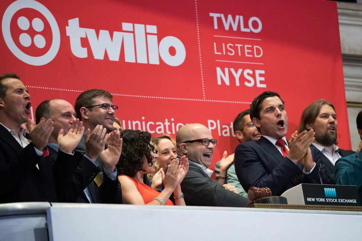 Twilio Inc. founder and CEO Jeff Lawson (C, in glasses) reacts after ringing the opening bell to celebrate Twilio's initial public offering at the New York Stock Exchange on June 23, 2016. (Drew Angerer/Getty Images)