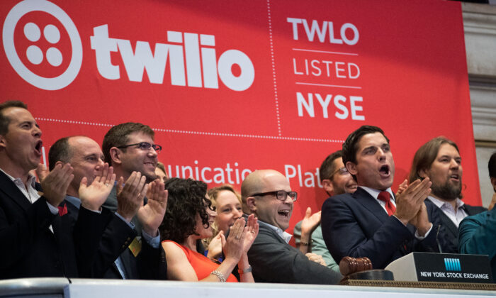 Twilio Inc. founder and CEO Jeff Lawson (C, in glasses) reacts after ringing the opening bell to celebrate Twilio's initial public offering at the New York Stock Exchange on June 23, 2016. (Drew Angerer/Getty Images)