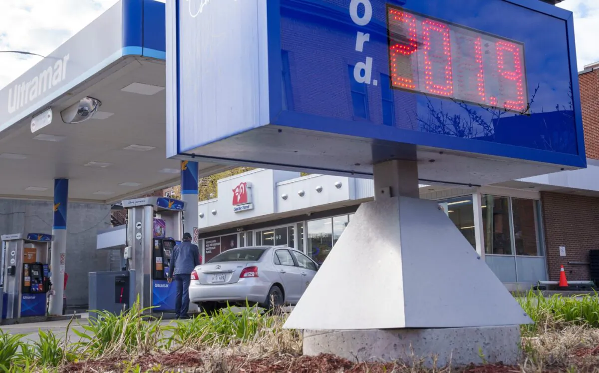 The price of gas is seen as a motorist fills up at a gas station in Montreal on May 6, 2022. (The Canadian Press/Paul Chiasson)