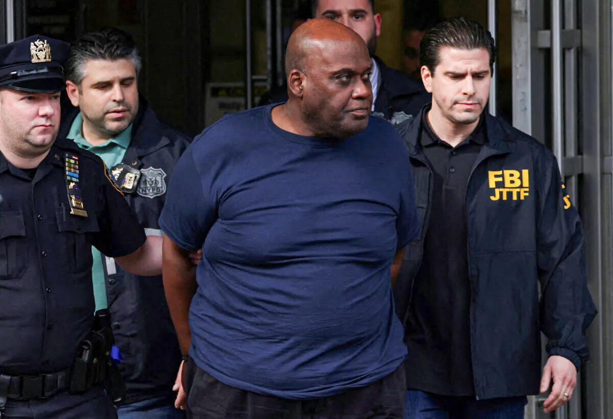 Frank James, the suspect in the Brooklyn subway shooting, walks outside a police precinct in New York on April 13, 2022. (Andrew Kelly/Reuters)