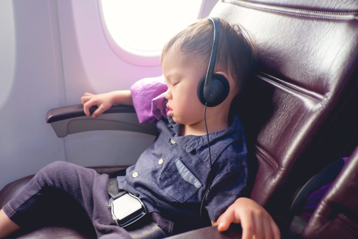 Toddler sleeping on airplane. (Dreamstime)