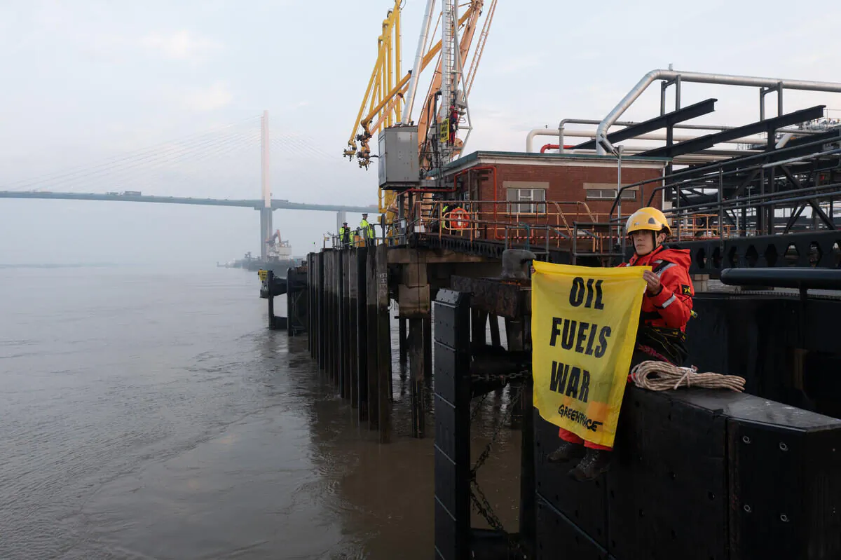Greenpeace climbers block a tanker carrying 33,000 tonnes of Russian diesel to the UK, at Navigator Terminals in Essex on May 16, 2022. (Greenpeace/ Saf Suleyman/ PA)