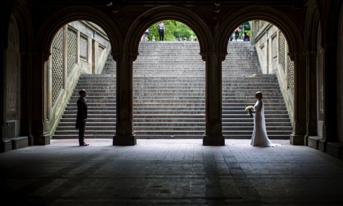 A bride and groom pose for wedding pictures at the Bethesda Terrace in New York's Central Park on May 23, 2017. (Mary Altaffer/AP Photo)