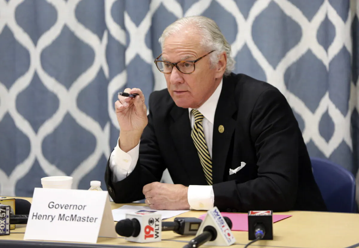 South Carolina Gov. Henry McMaster looks at data about the COVID-19 spread in the Kershaw County School District during a discussion with school officials at Camden Elementary School in Camden, S.C., on Sept. 15, 2021. (Jeffrey Collins/AP Photo)