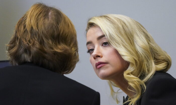 Actress Amber Heard talks with her lawyer Elaine Bredehoft in the courtroom at the Fairfax County Circuit Courthouse in Fairfax, Va., on May 18, 2022. (Kevin Lamarque/Pool Photo via AP)