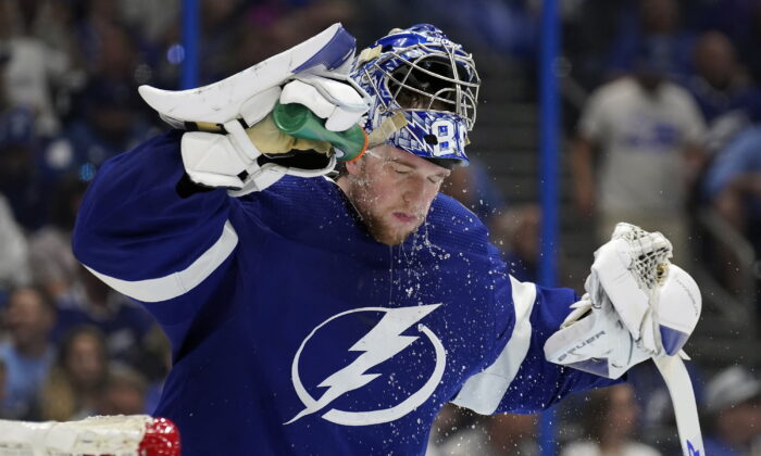 Tampa Bay Lightning goaltender Andrei Vasilevskiy (88) sprays water on his face during a timeout against the Florida Panthers during the third period in Game 4 of an NHL hockey second-round playoff series in Tampa, Fla., on May 23, 2022. (Chris O'Meara/AP Photo)