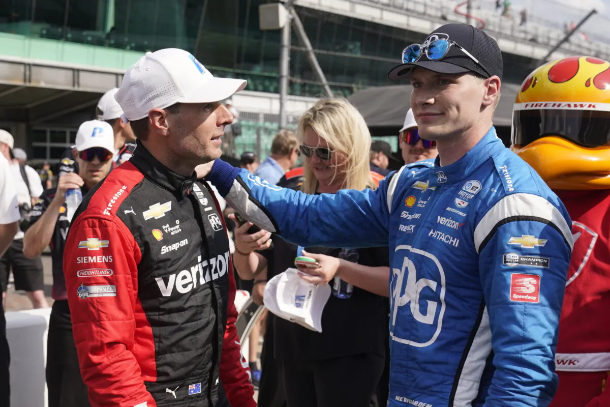 Will Power (L) of Australia is congratulated by Josef Newgarden after Power won the pole for the IndyCar auto race at Indianapolis Motor Speedway in Indianapolis on May 13, 2022. (Darron Cummings/AP Photo)