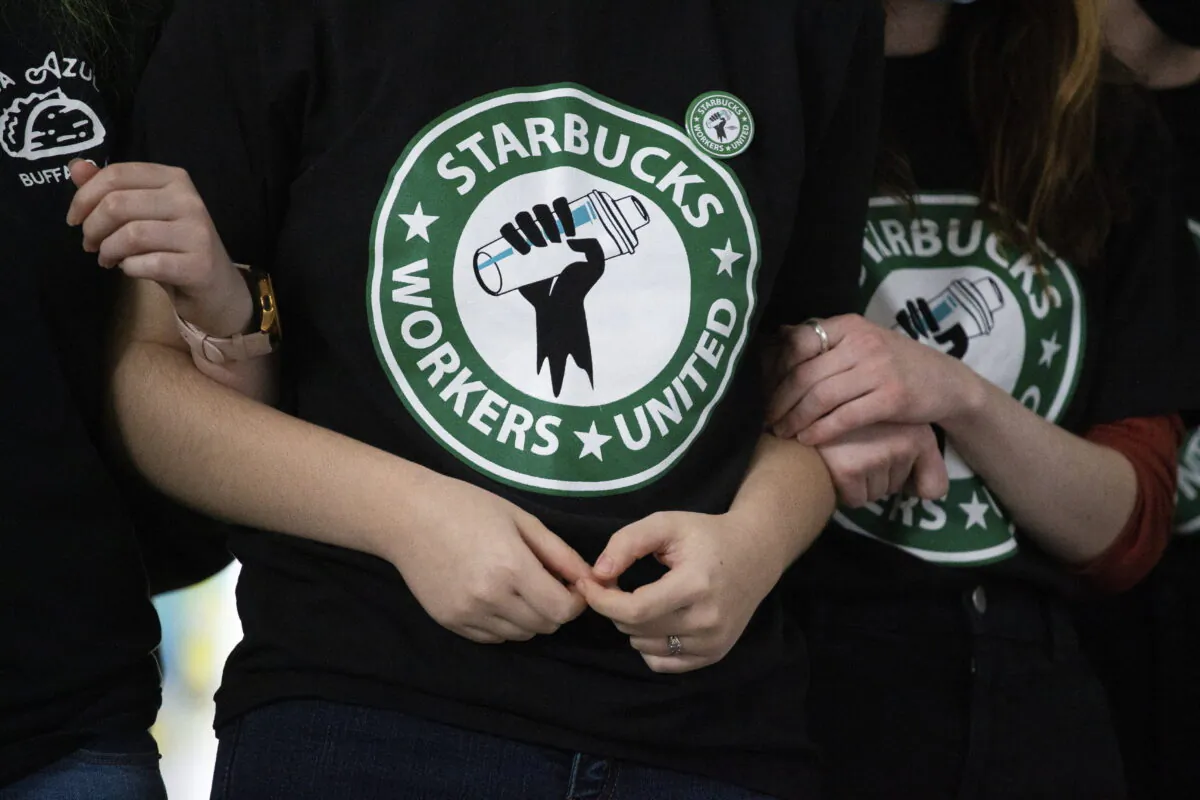 Starbucks employees and supporters react as votes are read during a union-election watch party in Buffalo, N.Y., on Dec. 9, 2021. (Joshua Bessex/AP Photo)