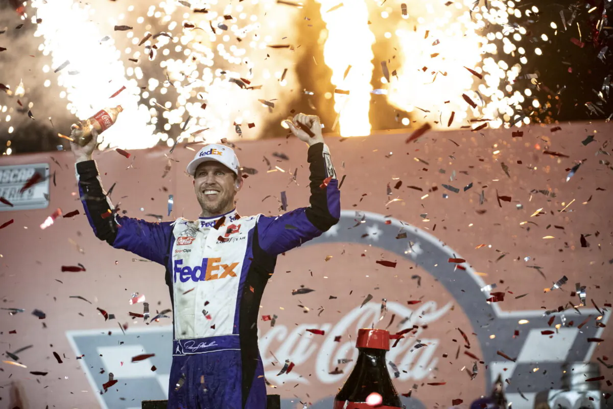 Denny Hamlin celebrates in Victory Lane after winning a NASCAR Cup Series auto race at Charlotte Motor Speedway in Concord, N.C., on May 29, 2022. (Matt Kelley/AP Photo)