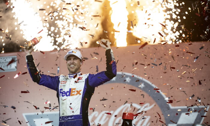 Denny Hamlin celebrates in Victory Lane after winning a NASCAR Cup Series auto race at Charlotte Motor Speedway in Concord, N.C., on May 29, 2022. (Matt Kelley/AP Photo)