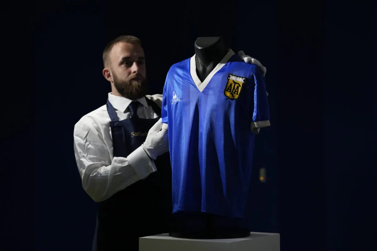The Argentina football shirt worn by Diego Maradona in the 1986 Mexico World Cup quarterfinal soccer match between Argentina and England, is displayed for photographs at Sotheby's auction house, in London, on April 20, 2022. (Matt Dunham/AP Photo)