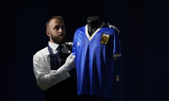 The Argentina football shirt worn by Diego Maradona in the 1986 Mexico World Cup quarterfinal soccer match between Argentina and England, is displayed for photographs at Sotheby's auction house, in London, on April 20, 2022. (Matt Dunham/AP Photo)