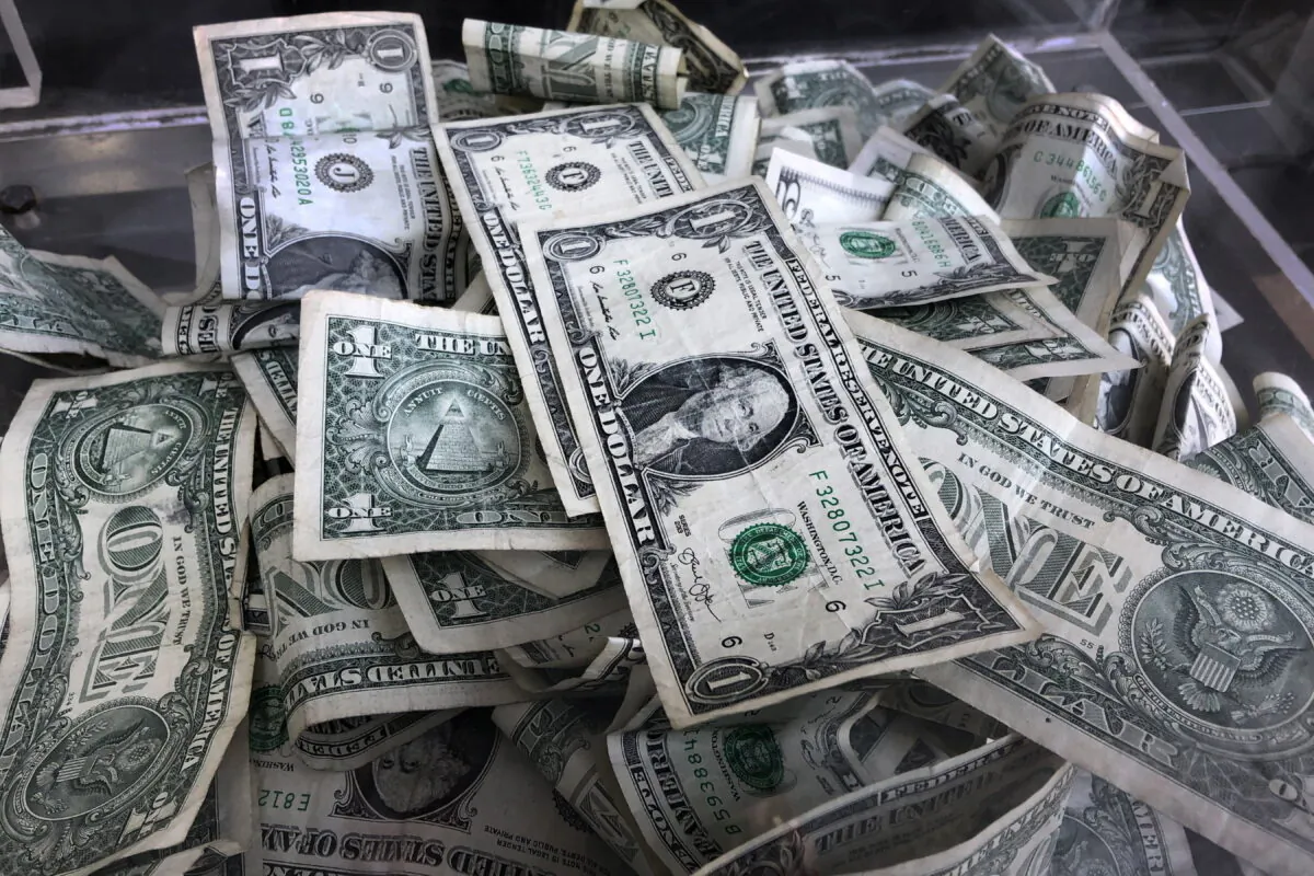 A tip box is filled with U.S. currency in New York on April 3, 2019. (Mark Lennihan/AP Photo)