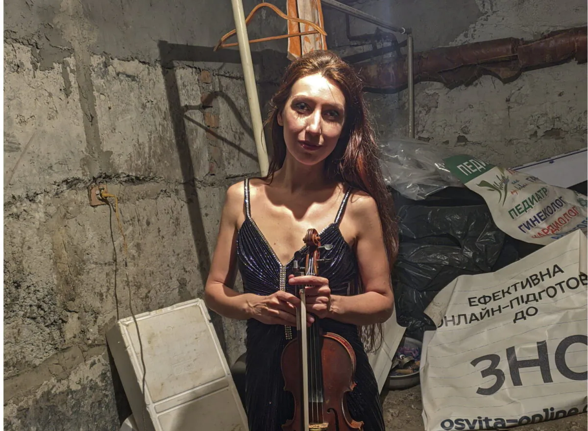 Violinist Vera Lytovchenko stands in a cellar with her violin in Kharkiv, Ukraine, on March 4, 2022. (Vera Lytovchenko via AP)