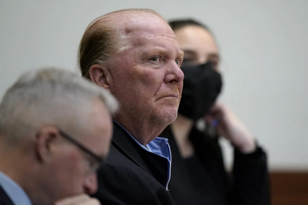 Celebrity chef Mario Batali (C) seat next to defense attorney Anthony Fuller (L) at Boston Municipal Court for the first day of Batali's pandemic-delayed trial in Boston on May 9, 2022. (Steven Senne/AP Photo)