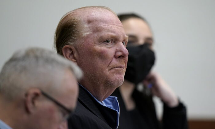 Celebrity chef Mario Batali (C) seat next to defense attorney Anthony Fuller (L) at Boston Municipal Court for the first day of Batali's pandemic-delayed trial in Boston on May 9, 2022. (Steven Senne/AP Photo)
