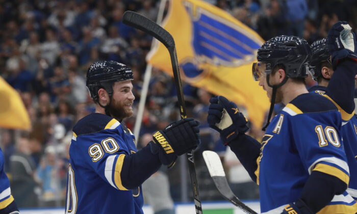 St. Louis Blues' Ryan O'Reilly (90) and Brayden Schenn (10) celebrate after the Blues defeated the Minnesota Wild in Game 6 of an NHL hockey Stanley Cup first-round playoff series in St. Louis, on May 12, 2022. The Blues advance to the second round. (Michael Thomas/AP Photo)