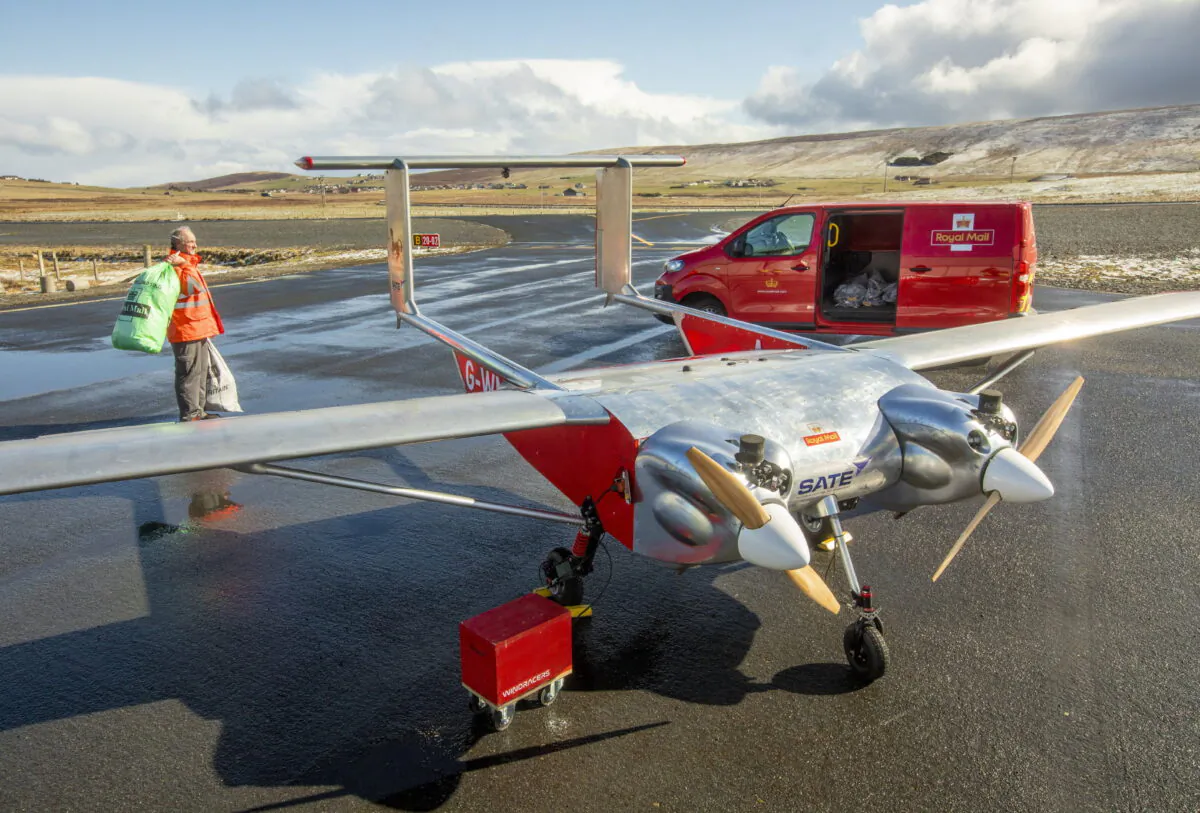 A large, twin-engine UAV operated by Windracers stands by a Royal Mail van in this undated handout image. (Royal Mail/PA)