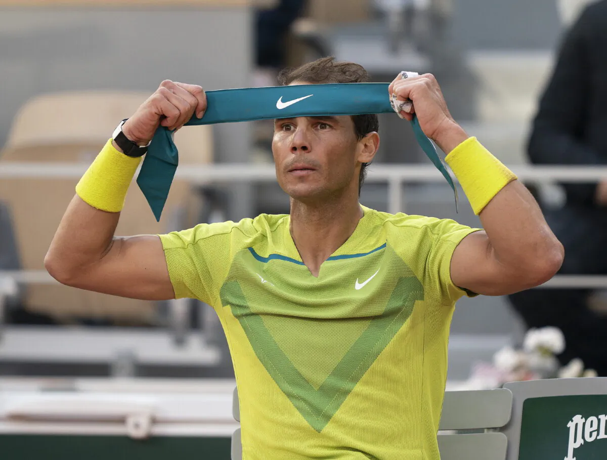 Rafael Nadal of Spain puts on a new bandana during a change of ends during his match against Felix Auger-Aliassime of Canada on day eight of the French Open at Stade Roland-Garros in Paris on May 29, 2022. (Susan Mullane/USA TODAY Sports via Reuters)