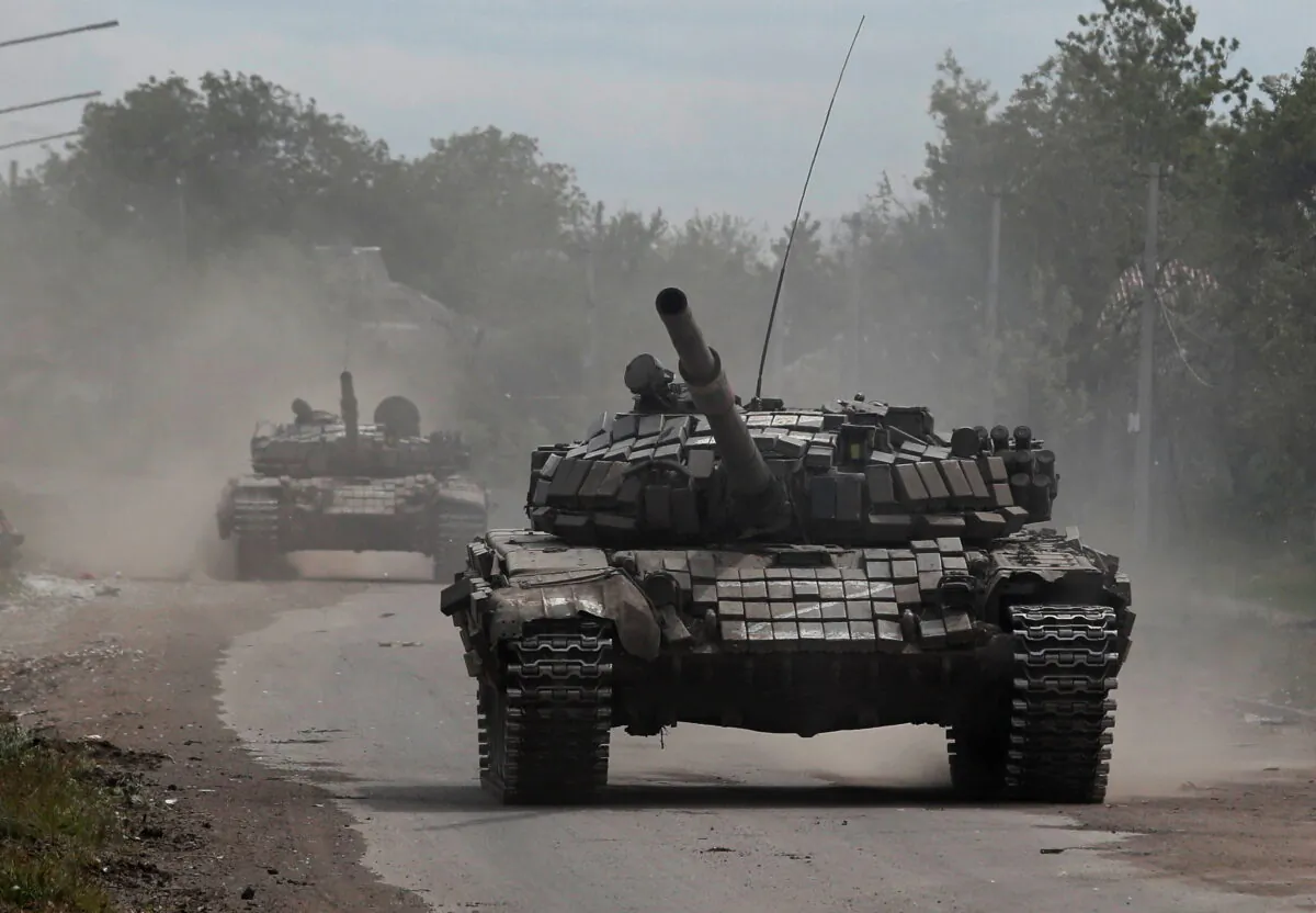 Tanks of pro-Russian troops drive along a street during Ukraine-Russia conflict in the town of Popasna in the Luhansk Region, Ukraine, on May 26, 2022. (Alexander Ermochenko/Reuters)
