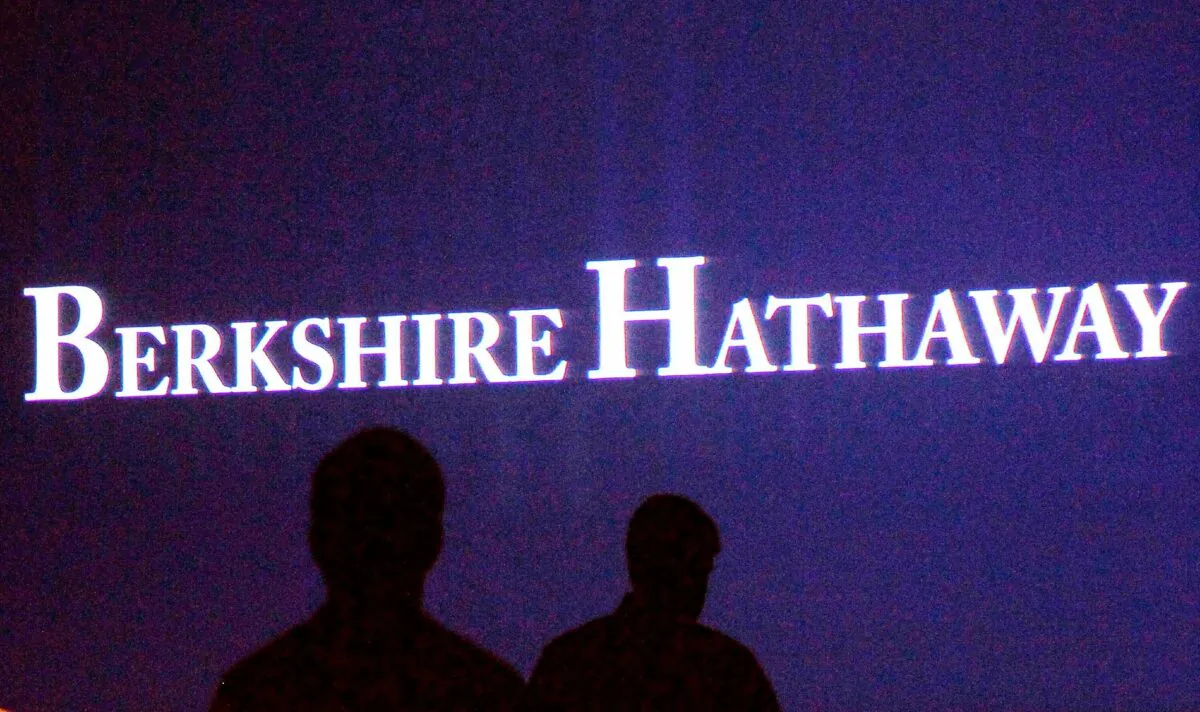 Berkshire Hathaway shareholders walk by a video screen at the company's annual meeting in Omaha, on May 4, 2013. (Rick Wilking/Reuters)