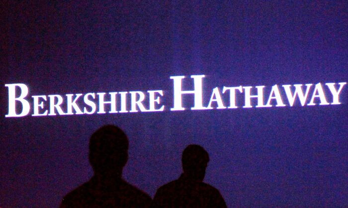 Berkshire Hathaway shareholders walk by a video screen at the company's annual meeting in Omaha, on May 4, 2013. (Rick Wilking/Reuters)