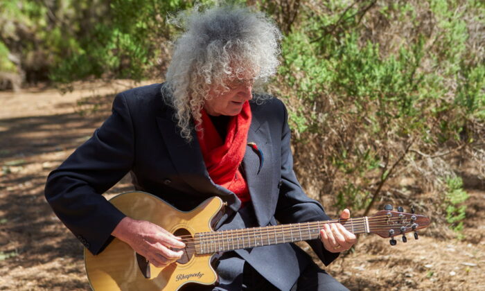 Musician Brian May plays the guitar while making a music video in Teide National Park, Tenerife, Spain, in a file photo. (Richard Gray/Duck Productions/Handout via Reuters) 