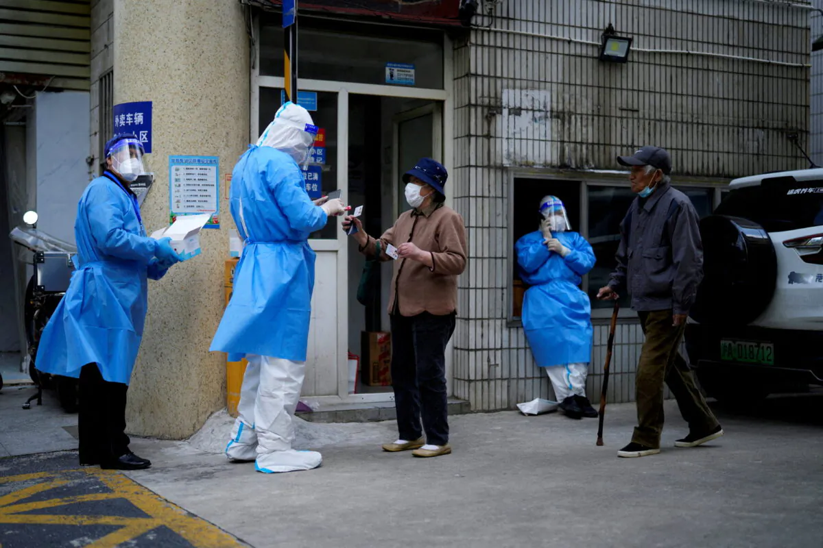 Residents line up for nucleic acid tests during lockdown in Shanghai on April 30, 2022. (Aly Song/Reuters)