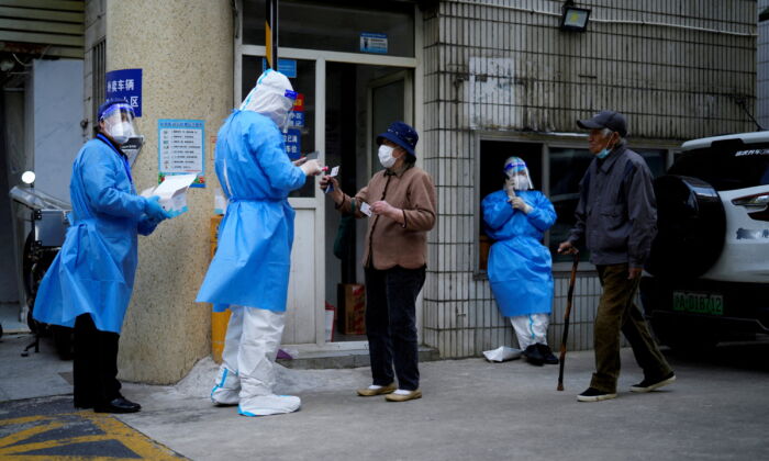 Residents line up for nucleic acid tests during lockdown in Shanghai on April 30, 2022. (Aly Song/Reuters)