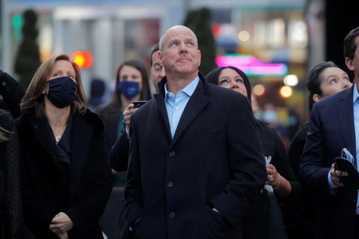 Jon Winkelried, CEO of private-equity firm TPG, celebrates his company's IPO outside the Nasdaq Market site in Times Square in New York, on Jan. 13, 2022. (Brendan McDermid/Reuters)