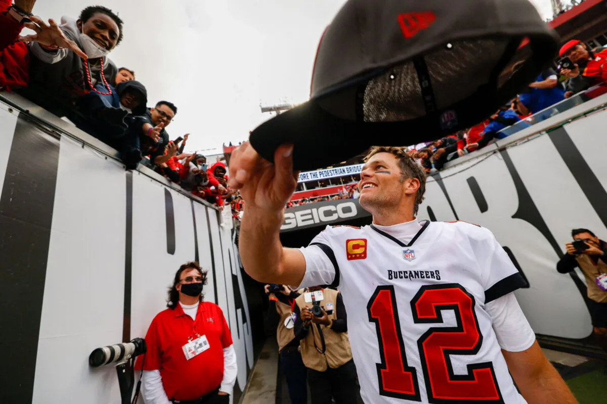 Tampa Bay Buccaneers quarterback Tom Brady (12) hands his hat to a fan after beating the Philadelphia Eagles 31–15 in a NFC Wild Card playoff football game at Raymond James Stadium in Tampa, Fla.. ( Nathan Ray Seebeck/USA Today Sports )