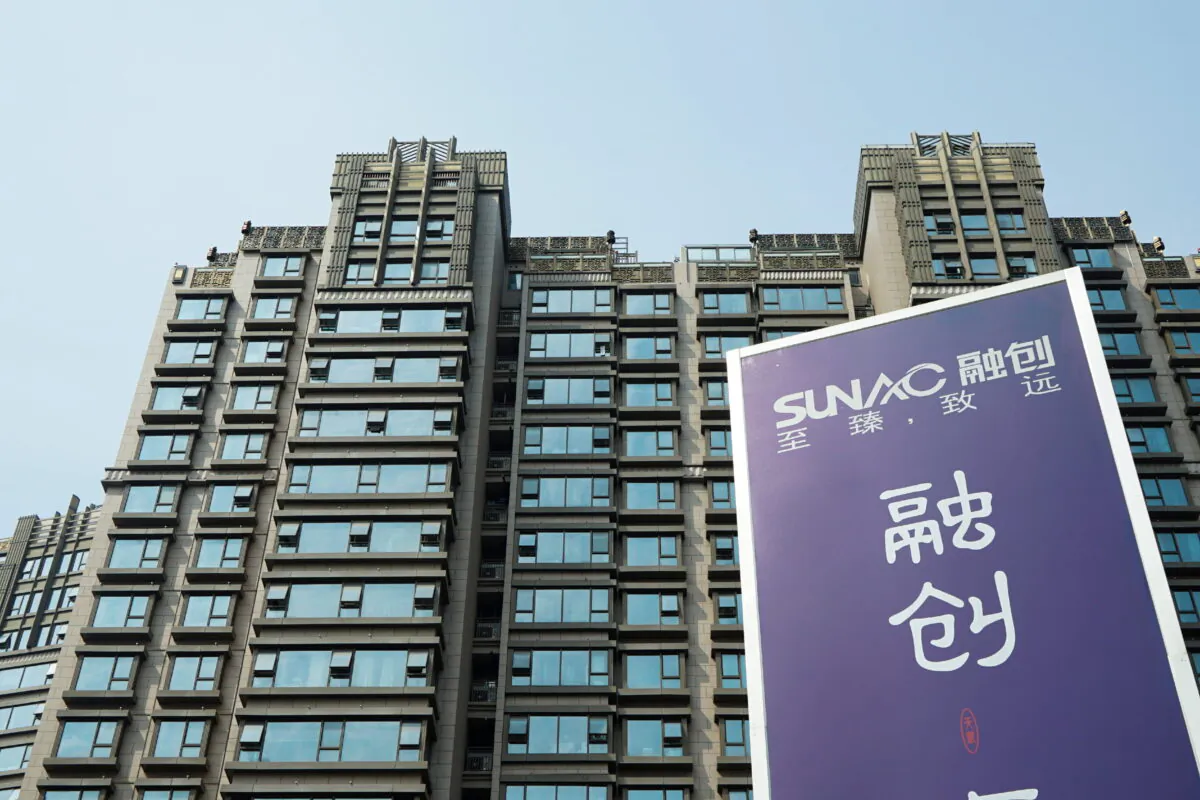 An advertisement of property developer Sunac China Holdings at a residential complex in Shanghai on March 25, 2018.   (Stringer/Reuters) 
