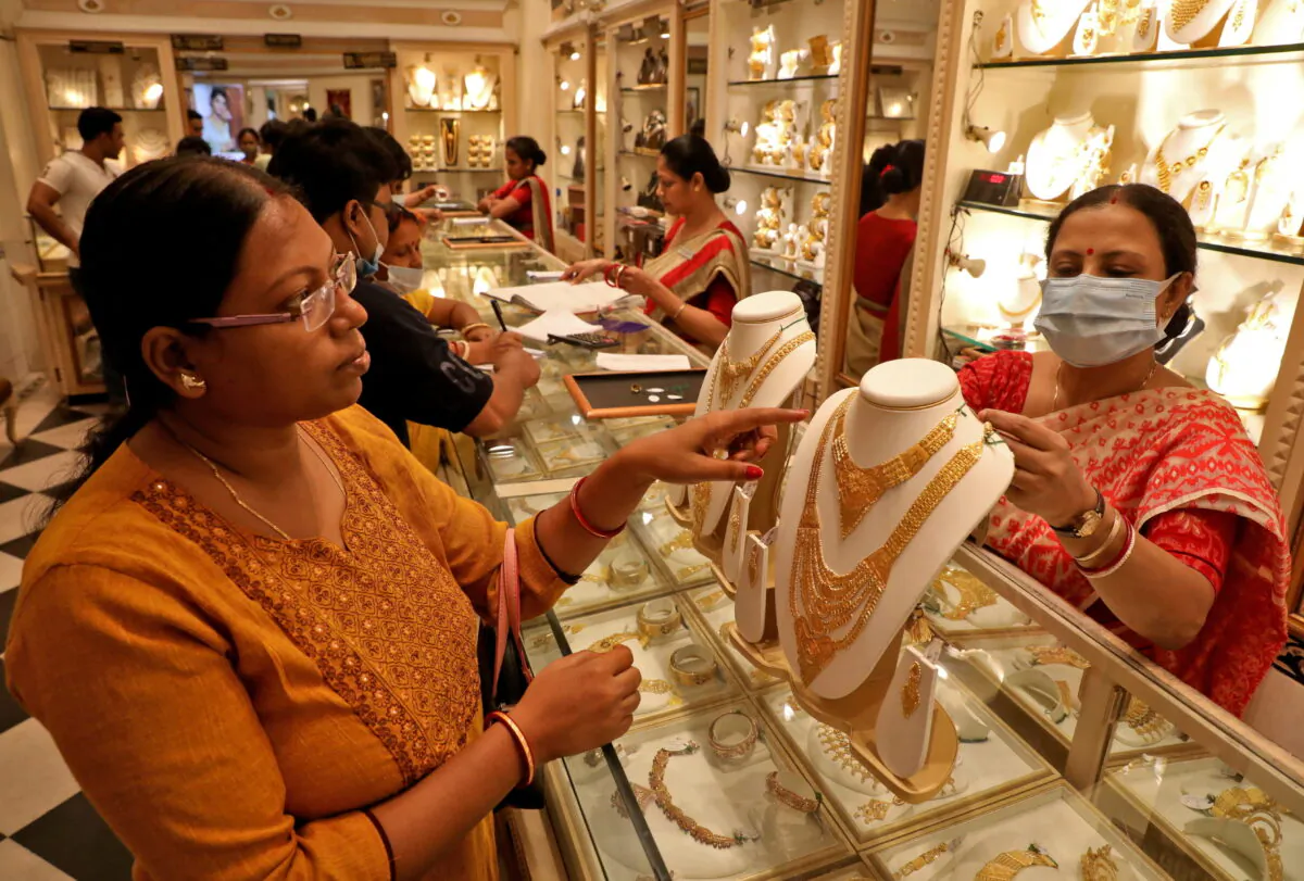 A customer checks a gold necklace before buying it at a jewellery showroom on the occasion of Akshaya Tritiya, a major gold buying festival, in Kolkata, India, on May 3, 2022. (Rupak De Chowdhuri/Reuters)