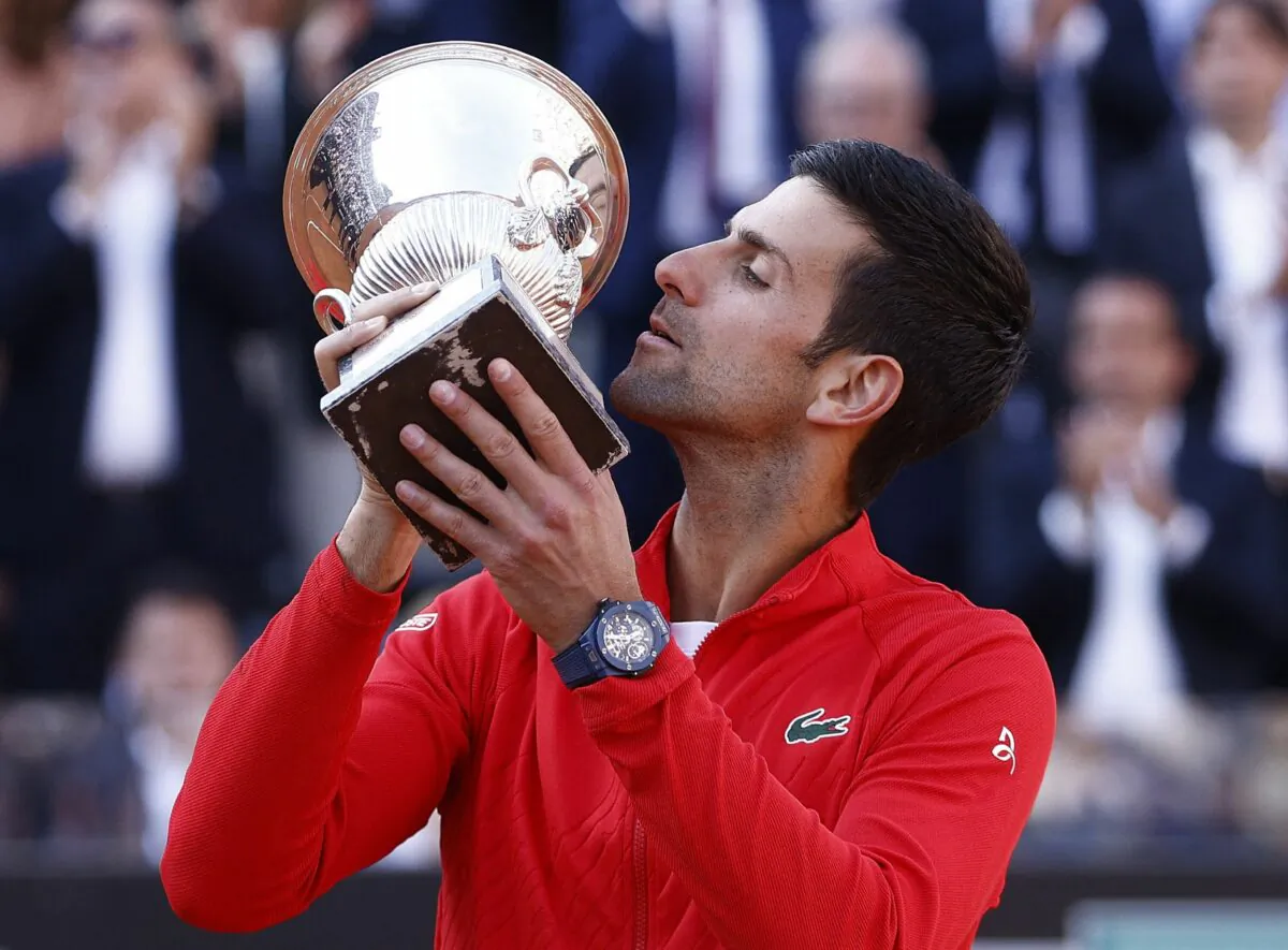 Serbia's Novak Djokovic celebrates with the winner's trophy after winning the final against Greece's Stefanos Tsitsipas, at the Italian Open at Foro Italico in Rome on May 15, 2022. (Guglielmo Mangiapane/Reuters)