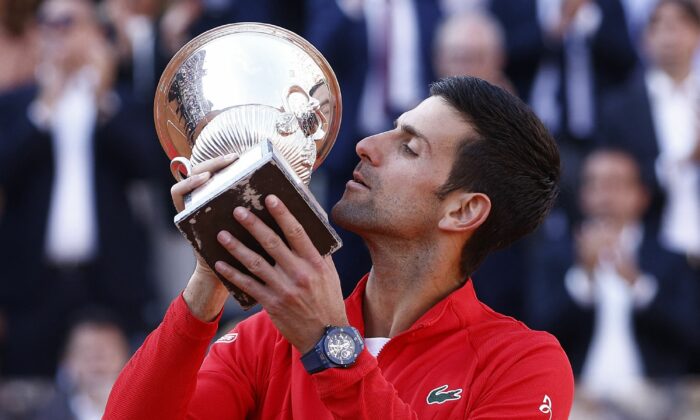 Serbia's Novak Djokovic celebrates with the winner's trophy after winning the final against Greece's Stefanos Tsitsipas, at the Italian Open at Foro Italico in Rome on May 15, 2022. (Guglielmo Mangiapane/Reuters)