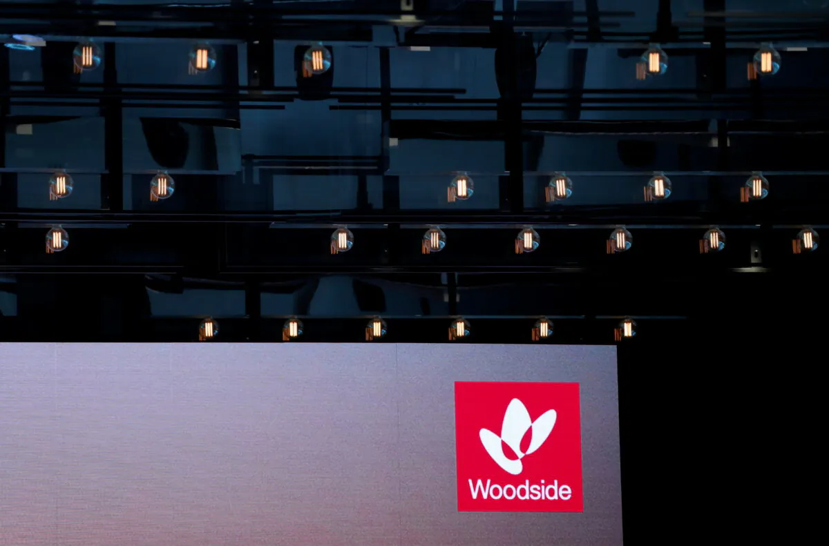 The logo for Woodside Petroleum, Australia's top independent oil and gas company, is projected onto a screen at a briefing for investors in Sydney, Australia, on May 23, 2018. (David Gray/Reuters)